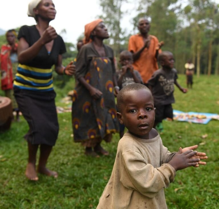 Community members dancing with guests in Uganda